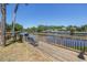 Wooden deck with a bench and grill overlooking the serene waterfront view, perfect for relaxing outdoors at 9105 W Hillsborough Ave # I102, Tampa, FL 33615