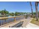 A spacious wooden dock with bench seating provides a stunning waterfront view surrounded by palm trees at 9105 W Hillsborough Ave # I102, Tampa, FL 33615