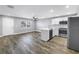 Open-concept kitchen features modern appliances, white cabinets, island with sink, and ceiling fan at 9105 W Hillsborough Ave # I102, Tampa, FL 33615