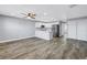 Open-concept living space with kitchen, stainless steel appliances, and wood-look flooring at 9105 W Hillsborough Ave # I102, Tampa, FL 33615