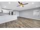 Open-concept living space with modern kitchen island and wood-look flooring at 9105 W Hillsborough Ave # I102, Tampa, FL 33615