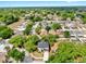 Aerial view of a home with a dark roof situated in a neighborhood with lush, mature trees at 934 Grand Canyon Dr, Valrico, FL 33594