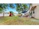 Expansive backyard showcasing a playset, patio seating area, and lush lawn, ideal for outdoor activities at 934 Grand Canyon Dr, Valrico, FL 33594