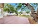 Spacious backyard with a patio, playset, and mature trees, creating a great space for Gathering fun and relaxation at 934 Grand Canyon Dr, Valrico, FL 33594