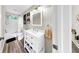 Bright bathroom featuring a white vanity, wood-look flooring, and a shower-tub combination at 934 Grand Canyon Dr, Valrico, FL 33594
