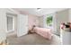 Bright bedroom featuring pink accents, soft carpet, and a sunlit window, creating a cozy and inviting space at 934 Grand Canyon Dr, Valrico, FL 33594