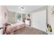 This cozy bedroom features a pink accent wall, window with natural light and a spacious closet at 934 Grand Canyon Dr, Valrico, FL 33594