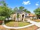 Charming two-story home with a well-maintained lawn, arched entryway, and beautiful landscaping at 934 Grand Canyon Dr, Valrico, FL 33594