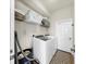 Laundry room featuring a modern washer and dryer with storage shelves and cabinets at 934 Grand Canyon Dr, Valrico, FL 33594