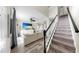 Expansive living room featuring modern furniture and a staircase with dark wood railings at 934 Grand Canyon Dr, Valrico, FL 33594