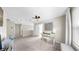 The loft offers ample space with a white desk, neutral walls, carpet floors, and a sunlit window at 934 Grand Canyon Dr, Valrico, FL 33594