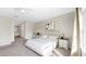 This bright, neutral main bedroom features plush carpeting, a walk-in closet, and an attached bathroom at 934 Grand Canyon Dr, Valrico, FL 33594