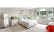 Bright main bedroom features neutral colors, plush carpet, and a large window for plenty of natural light at 934 Grand Canyon Dr, Valrico, FL 33594