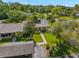 Aerial view showcasing the property, its surrounding landscaping, a pond, and a carport at 10 James Ct, Oldsmar, FL 34677