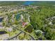 An aerial view of the home's setting in a verdant community with a lake and swimming pool at 10 James Ct, Oldsmar, FL 34677