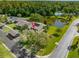 Aerial view highlighting the property's location near the pond, landscaping and community pool at 10 James Ct, Oldsmar, FL 34677