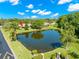 Aerial view of the community featuring the property, the pond, and verdant landscaping at 10 James Ct, Oldsmar, FL 34677