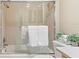 Bright bathroom featuring a shower over tub, ceramic tile walls, and decorative plants at 10 James Ct, Oldsmar, FL 34677