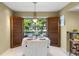 Inviting dining room featuring charming plantation shutters and a view of the outdoors at 10 James Ct, Oldsmar, FL 34677