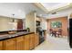 Bright kitchen with wooden cabinets, black appliances, and a cozy breakfast table near the window at 10 James Ct, Oldsmar, FL 34677