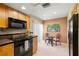Cozy eat-in kitchen area with black appliances and view of the outdoors at 10 James Ct, Oldsmar, FL 34677