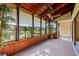 Enclosed lanai with wood paneling and view of pond, offering serene indoor-outdoor living at 10 James Ct, Oldsmar, FL 34677