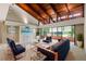 Bright living room featuring wood-beamed ceilings, neutral walls, and modern furnishings, creating an airy, inviting space at 10 James Ct, Oldsmar, FL 34677