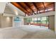 Spacious living room with vaulted wood ceiling, large windows, and neutral carpet at 10 James Ct, Oldsmar, FL 34677