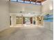 Spacious living room with a vaulted ceiling, seamlessly connecting dining and kitchen areas at 10 James Ct, Oldsmar, FL 34677