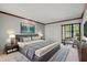 Well-lit main bedroom with a plush rug, a comfortable seating area, and an elegant headboard at 10 James Ct, Oldsmar, FL 34677