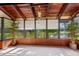 Bright sunroom with lake views, light carpet, wood-paneled walls, and bright natural light at 10 James Ct, Oldsmar, FL 34677