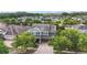 Aerial view of a two-story home featuring a three-car garage, mature trees, and manicured lawn at 10007 Hazelnut Ct, Tampa, FL 33647