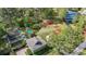 An aerial shot of a well landscaped backyard including a putting green and covered sports court area at 10007 Hazelnut Ct, Tampa, FL 33647