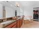 Beautiful Primary bathroom featuring a soaking tub, and sinks, and walk-in closet at 10007 Hazelnut Ct, Tampa, FL 33647