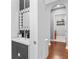 Stylish bathroom with patterned tile and adjacent hallway, showcasing sleek vanity, mirror, and practical storage at 10007 Hazelnut Ct, Tampa, FL 33647