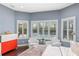 Bright bedroom boasts lots of natural light, white shutters and features two comfortable white chairs at 10007 Hazelnut Ct, Tampa, FL 33647