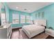Bedroom features include blue walls, hardwood floors, neutral rug and natural light at 10007 Hazelnut Ct, Tampa, FL 33647