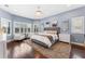 Serene main bedroom retreat featuring hardwood floors and abundant natural light, ideal for relaxation at 10007 Hazelnut Ct, Tampa, FL 33647