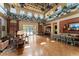 This is a bright clubhouse with high ceilings, ceiling fans, tables, chairs and couches at 10007 Hazelnut Ct, Tampa, FL 33647
