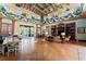 This is a bright clubhouse with high ceilings, ceiling fans, tables, chairs and couches at 10007 Hazelnut Ct, Tampa, FL 33647