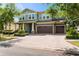 Charming two-story home with a brick driveway, well-kept landscaping, and a spacious three-car garage at 10007 Hazelnut Ct, Tampa, FL 33647