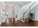 Bright foyer showcasing hardwood floors, elegant staircase, and decorative lighting, welcoming guests into a stylish home at 10007 Hazelnut Ct, Tampa, FL 33647