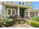 Inviting front porch with stone accents, lush landscaping, and a cozy seating area at 10007 Hazelnut Ct, Tampa, FL 33647
