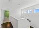 Bright upstairs landing with hardwood floors, white trim, and natural light at 10007 Hazelnut Ct, Tampa, FL 33647