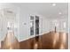 Upstairs hallway featuring hardwood floors and glass french doors to the media room at 10007 Hazelnut Ct, Tampa, FL 33647