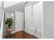 Hallway with modern decor leading to a half bathroom with patterned tile, enhancing the home's aesthetic at 10007 Hazelnut Ct, Tampa, FL 33647