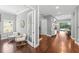 Hallway with hardwood floors, modern decor, and views to the backyard and office at 10007 Hazelnut Ct, Tampa, FL 33647