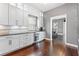 Bright kitchen features gray cabinets, dark countertops, stainless steel appliances, and hard wood flooring at 10007 Hazelnut Ct, Tampa, FL 33647
