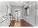 Bright kitchen features gray cabinets, a drink cooler, dark countertops, and hardwood floors at 10007 Hazelnut Ct, Tampa, FL 33647
