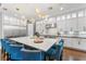 Spacious kitchen featuring a large island with seating, stainless steel appliances, and elegant lighting, ideal for gatherings at 10007 Hazelnut Ct, Tampa, FL 33647